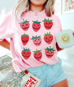 Strawberry Shirt Comfort Colors Halloween Shirt Please send a message if your desired color, size or garment style/brand is not available! Be sure to check the size chart within the listing. Most of the models are wearing oversized apparel. Size up from your usual size to achieve this look! TEE INFO/CARE: * Garment Dyed 100% cotton * Pre-Shrunk * Unisex, Loose fit * Wash inside out in COLD water * Lay flat to dry or machine dry on LOWEST setting * Iron on low * Do NOT dry clean Printed with eco- Playful Halloween T-shirt With Cartoon Print, Halloween Pink T-shirt With Screen Print, Pink Halloween T-shirt With Screen Print, Novelty Pink Crew Neck T-shirt, Playful Pre-shrunk Tops For Halloween, Pink T-shirt With Funny Print For Fall, Kawaii Short Sleeve Shirt With Character Print, Fun Strawberry Print Crew Neck T-shirt, Cute Long Sleeve Shirt With Funny Print