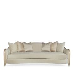 an image of a couch with pillows on it's back and the seat upholstered