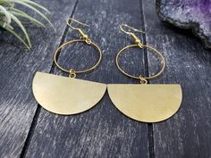 "These geometric statement earrings feature 35mm x 22.5mm raw brass half moon or semi-circle charms dangling from 25mm gold-plated brass circles. The ear wires are made from gold-plated surgical steel, making these earrings safe for sensitive ears. They are very lightweight and measure approximately 2.5 inches from the top of the ear wire to the bottom of the half circle charm. Domestic shipping is always free here at Mayamadethis! When will my item ship? Every single item here at MayaMadeThis i Minimalist Circle Brass Earrings, Minimalist Brass Half Moon Jewelry, Minimalist Half Moon Brass Jewelry, Gold Semi-circle Metal Earrings, Modern Crescent Brass Earrings, Brass Earrings With Moon Charm In Half Moon Shape, Brass Half Moon Earrings For Gift, Everyday Metal Crescent Earrings, Everyday Crescent Metal Earrings