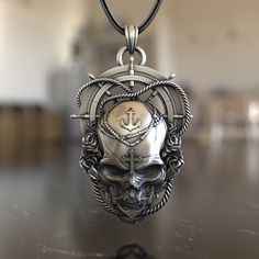 Embark on a maritime adventure with our Sea Skull Steering Wheel 925 Sterling Silver Necklace. This piece is a captivating blend of nautical charm and gothic allure, capturing the essence of the mysterious deep blue and its legends. Expertly crafted from premium 925 sterling silver, the necklace features a detailed pendant combining a skull and a ship's steering wheel, symbolizing the unpredictable nature of the sea and the mysteries it holds. Its intricate design ensures it stands out, making i Silver Anchor-shaped Metal Jewelry, Silver Anchor Shaped Metal Jewelry, Silver Anchor-shaped Jewelry In Metal, Nautical Style Metal Jewelry Gift, Symbolic Silver Anchor Jewelry, Silver Necklace With Engraved Anchor Pendant, Silver Anchor-shaped Nautical Jewelry, Silver Nautical Anchor Jewelry, Nautical Style Silver Anchor Jewelry