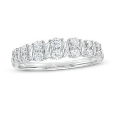 a white gold ring with three stones on the side and two rows of diamonds in each band