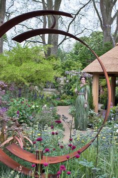 a woman standing in the middle of a garden