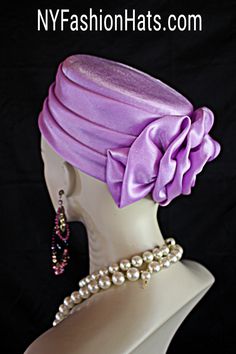 Women's Soft Lavender Purple Satin Couture Formal Pillbox Cocktail Wedding Church Hat. This Classic Styled Dressy Pillbox Holiday Hat Is Embellished With A Satin Bow Enhanced With A Rhinestone. This Bridal Mother Of The Bride Headpiece Can Be Worn With Embellishments Toward The Face Or To The Back Of The Head. This Elegant Satin Pillbox Hat Is Custom Made And Designed By NY Fashion Hats Couture Millinery. https://www.nyfashionhats.com. This New Collection Headpiece Is Part Of The Anastasia Konstandina Couture Headdress Line. This ladies bespoke pillbox hat is appropriate to wear for horse races, The Kentucky Derby, The Dubai World Cup, The Royal Ascot, The Melbourne Cup, Belmont Stakes, The Preakness Stakes horse racing, Church, weddings, and special occasion. This hat is also suited for m Mother Of The Bride Hats, Bespoke Hats, Preakness Stakes, Veiled Hats, Couture Hats, Church Hat, Bride Hat, Bridal Hat, Wedding Church