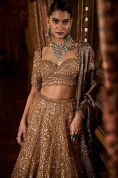 This lehenga set features intricate embroidery in sequin, bead and crystal on a deep mustard tissue organza base. The elbow sleeve blouse has tassels at sleeve hem and waist and is paired with a contrasting maroon tissue dupatta with matching heavy embroidery.From Seema Gujral's Falaknuma collection. DELIVERY TIMEPlease allow 8-12 weeks for your outfit to arrive. FABRIC DETAILSTissue Organza Professional cleaning only. Glamorous Tissue Silk Sets With Zari Work, Glamorous Tissue Silk Sets With Dupatta, Glamorous Tissue Silk Lehenga For Designer Wear, Glamorous Tissue Silk Sets For Reception, Glamorous Tissue Silk Choli For Festive Occasions, Glamorous Festive Tissue Silk Choli, Diwali Glamorous Tissue Silk Lehenga, Tissue Lehenga, Elbow Sleeve Blouse