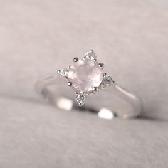 ◆The ring draws inspiration from the polaris. Hand-finished in Sterling sliver, this piece features a round shaped pink quartz. Clear zirzons decorate around the main stone. An extremely simple celestial ring that you cannot miss. ◆ Production Description: Main stone Type: Pink Quartz Main Stone Shape: Round Main Stone Size: 6*6mm Side stone: CZ Metal: 925 Sterling silver - Other options available in the drop down menu ◆ Customization: √Free for Add Engraving √Other Metal Type Available √Other G Rose Engagement Ring Vintage, Pink Quartz Ring, Rose Quartz Ring Engagement, Promise Rings Simple, July Birthstone Ring, Green Sapphire Ring, Celestial Ring, Minimalist Engagement Ring, London Blue Topaz Ring