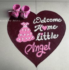 a welcome home little angel rug with baby shoes