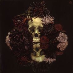 a painting of a skull surrounded by flowers