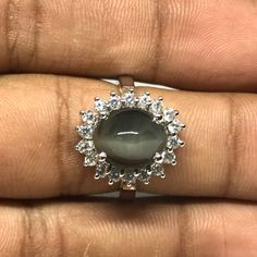 Welcome to Elegant Art Jewelry!  Material: 925 Sterling Silver Stone: Cats Eye Side Stone: Zircoin Stone Cut: Oval Cabution Personalization: 9K/14K/24K/GOLD/SILVER/PLATINUM/ROSE-GOLD/WHITE GOLD. (Contact me)  Cats Eye Ring, Cats Eye Cuff Ring, 14k White Gold Ring, Oval Shape Ring, Cats Eye Ring, Cats Eye Engagement, Open Design Ring, Cats Eye Oval, Cats Eye Natural, Gray Cats Eye, Gray Gemstone, Gemstone Ring, Engagement Ring, Wedding Ring, Statement Ring, Cats Eye Ring, Victorian Ring, Cats Eye Silver Oval Cabochon Jewelry With Halo Setting, Silver Moonstone Ring With Halo Setting, Silver Oval Cabochon Jewelry With Center Stone, Silver Oval Cabochon Rings With Halo Setting, Silver Ring With Oval Cabochon Center Stone, Silver Oval Cabochon Ring With Center Stone, Silver Cabochon Rings For Anniversary, Silver Oval Cabochon Ring With Prong Setting, Silver Oval Cabochon Promise Ring