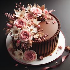 a chocolate cake with pink flowers on top