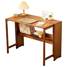 a wooden desk with books and a lamp on it's side table next to a book shelf