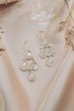 Connect with your inner natural beauty with our authentic Moonstone Earrings - Dew Drops. Sleek, stylish and feather-light, these pretty dangle earrings reflect the effortless beauty that comes from within. A statement such as our Dew Drops will take you from airy summer picnics to cozy winter get-togethers in style. A striking addition on their own or matched with your Dew Drops Necklace, these enchanting earrings are sure to become a favorite. Authentic Sivalya Moonstone Moonstone: Goddess Ene Drop Moonstone Earrings With Natural Stones, Elegant Moonstone Dangle Crystal Earrings, Elegant Moon Phase Earrings, Elegant Moonstone Teardrop Earrings, Elegant Teardrop Moonstone Earrings, Elegant White Moonstone Crystal Earrings, Elegant Moon Phase Dangle Jewelry, Elegant Chandelier Earrings With Natural Stones In Sterling Silver, Elegant Moonstone Drop Earrings