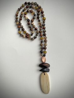 This 32" hand knotted, long beaded necklace, touches all of the neutrals. A perfect blend of agate, wood, glass and metal beading. A perfect start to a fall wardrobe. Long Beaded Necklaces, Beads Craft, Beaded Jewelry Necklaces, Hawaiian Jewelry, African Necklace, Moms Bracelet, Wood Bead Necklace, Long Necklaces, Handmade Jewelry Necklace