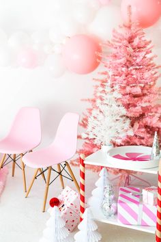 pink and white christmas decorations in a room