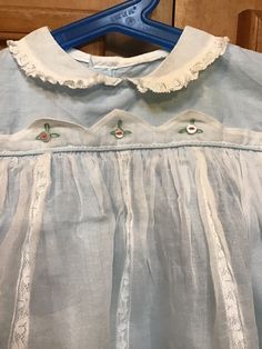 "Amazing beautiful infant dress from the 50s/60s, only issue a spot hardly noticeable from a distance under collar/I did not see it till I posted. (see last photo)No labels at all size or fabric. I feel like it is a cotton dress with a net overlay- gorgeous petite lace trim.Pit to pit 9 1/2\"/length (shoulder to bottom) 14\"/smoke free environment(65)" Vintage Blue Dress With Doll Collar, Cute Daywear Dresses With Peter Pan Collar, Vintage Cotton Dress For Dress-up, Vintage Summer Dresses For Playtime, Vintage Dresses For Summer Playtime, Summer Vintage Dresses For Playtime, Vintage Cotton Playtime Dress, Vintage Doll Collar Dress For Dress-up, Vintage Dress With Doll Collar For Dress-up