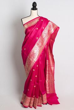 Add a touch of elegance to your wardrobe with our stunning Silk Mark Certified Pink Tussar Georgette Banarasi Saree. The vibrant pink color and intricate Banarasi weaving make it a perfect choice for weddings, festivals, and special occasions. With its timeless beauty and Silk Mark certification, you can be assured of the authenticity and superior quality of this saree. Elevate your traditional look with this gorgeous piece that exudes grace and sophistication. This is a SILK MARK CERTIFIED Saree. Blouse Piece : Yes. Fall Pico : Yes.  Care: Dry-Clean Only. Elegant Pink Traditional Wear With Pallu, Elegant Pink Art Silk Traditional Wear, Elegant Pink Traditional Wear With Zari Weaving, Pink Traditional Wear For Transitional Season, Transitional Pink Traditional Wear With Traditional Drape, Pink Saree With Dori Work For Traditional Ceremonies, Silk Traditional Wear With Dori Work In Pink, Pink Paithani Silk Traditional Wear With Resham Embroidery, Pink Silk Traditional Wear With Dori Work