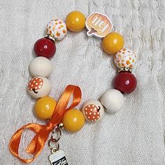 This Bracelet Has Wooden Beads In Fall Colors, A Wooden Fall Pumpkin Bead, Gold Bling Spacers, And A Cute Coffee Charm. All You Need Now Is The Boots And Sweater. Yellow Wooden Bead Bracelets, Yellow Wooden Beads Bracelet, Adjustable Yellow Bracelet With Wooden Beads, Yellow Bracelet With Round Wooden Beads, Yellow Beaded Bracelet With Colorful Beads For Gift, Yellow Beaded Bracelet With Multicolor Beads As Gift, Yellow Beaded Bracelet As A Gift, Yellow Beaded Bracelets With Colorful Beads As A Gift, Adjustable Yellow Wooden Beaded Bracelets