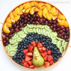 a plate filled with fruit and vegetables on top of a table