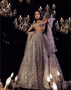 This lehenga set features platinum cut sequin and crystal embellishment in a cascade motif pattern. The ensemble is paired with a criss-cross back and fully embroidered net dupatta.From Seema Gujral's Tuscan Summer collection. DELIVERY TIMEPlease allow 4 months for your outfit to arrive. FABRIC DETAILSNet Professional cleaning only. Crystal Lehenga, Champagne Lehenga, Pretty Lehengas, Ball Gown Accessories, Silver Lehenga, Gota Patti Lehenga, Tuscan Summer, Beautiful Lehengas, Strappy Blouse