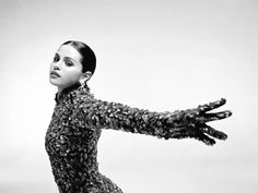 a black and white photo of a woman with her arms outstretched