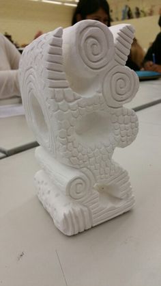 a white sculpture sitting on top of a table