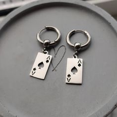 Super trendy lucky ace of spade Huggie hoop earrings in silver!♠️ Would make a great gift for any poker fan! Ear huggies and playing card charms are made of high quality stainless steel so these earrings are hypoallergenic and wont tarnish or discolour. Available as a single earring or as a pair. Hoops measure 17mm Charms measure 10x19mm Please don't hesitate to contact me with any queries or suggestions ☺️ Comes gift wrapped 🎁 Masc Earrings, Ear Huggies, Card Earrings, Mens Earrings, Earrings Men, Men's Earrings, Spade Earrings, Edgy Jewelry, Earrings For Men