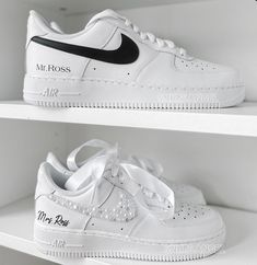 two white nike air force sneakers on shelves