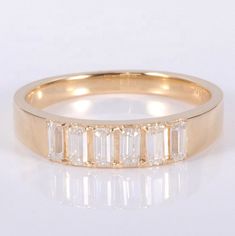 a yellow gold ring with five baguetts of diamonds