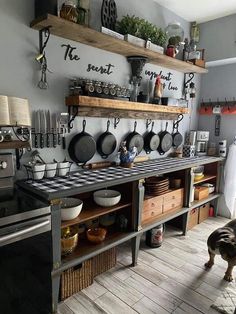 a kitchen with pots and pans hanging on the wall