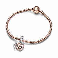 A jewelry gift for a mom who will always be perfect to you, just as she is. The Two-tone Infinity Heart Double Dangle Charm features an openwork heart dangle in 14k rose gold plating forming an infinity symbol in the center, adorned with a row of pink pavé and engraved with the word "Mom" with a pink stone as the central letter. Behind it is a sterling silver heart-shaped disc engraved with the message "To me you are perfect" creating a repeating pattern on both sides. Pink pavé on the bail adds a finishing touch. A celebration of motherly love in all its forms. Heart-shaped Rose Gold Charm Jewelry, Gold Elegant Charms For Mother's Day, Elegant Heart-shaped Charms For Gifts, Elegant Gold Charms For Mother's Day, Elegant Heart Shaped Charms For Gifts, Heart Charm As Gift, Fine Jewelry Charms As Gifts, Dangling Charms Jewelry For Valentine's Anniversary, Infinity Jewelry As A Gift For Mom