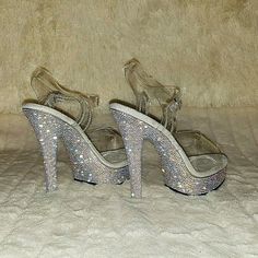 5" (132mm) Heel, 7/8" (25mm) Platform Comfort Width Ankle Strap Sandals Featuring Rhinestones Encrusted All-Over The Entire Platform Bottom Nicely Cushioned Comfort Width Foot-Bed New In Box Clear Heels With Rhinestones For Prom, Clear Heels With Rhinestones And Ankle Strap, Clear Rhinestone High Heels, Bedazzled Crystal High Heels, Crystal High Heels With Bling, Glamorous Clear Heels With Rhinestones, Pleaser High Heels, Clear Platform Heels, Pleaser Heels