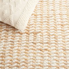 a close up view of a rug with white and tan colors on it's surface