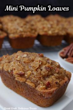 a close up of a muffin on a plate with pecans in the background