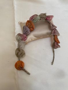 a piece of fabric with flowers attached to it