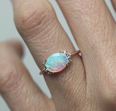 A gorgeous prong set Australian opal & diamond cluster engagement ring in 14k or 18k solid gold or platinum. The opal shines in a variety of special colors (blue, green, white, pink, ...). Lots of fire! This unique multi stone engagement, wedding or bridal cluster is available in 14k and 18k solid rose, white, yellow gold and platinum. Please select the material and ring size from the drop-down menu on the right side of the listing. If you have any questions, please send us a message. If you Oval Opal Ring, Morganite Engagement Ring Oval, Gold Opal Ring, Ruby Wedding Rings, October Birthstone Ring, Rose Gold Opal Ring, Australian Opal Ring, Rose Gold Engagement Ring Vintage, Solid Gold Bracelet