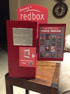 a red box sitting on top of a wooden table