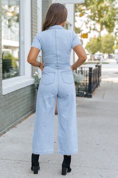 Complete with a zip up front, this short sleeve jumpsuit is perfect for effortless style! Expertly designed, this Light Denim Waist Tie Jumpsuit features a collared neckline and wide leg silhouette for a classic and flattering look. The waist tie allows for a customizable fit, while side pockets add convenience. Pair with comfy sandals or sneakers along with some elevated gold jewelry for a casual chic everyday look. Cotton Denim Jumpsuit With Short Sleeves, Workwear Denim Jumpsuit With Short Sleeves, Short Sleeve Denim Jumpsuit For Work, Short Sleeve Denim Jumpsuit With Pockets, Casual Short Sleeve Overalls For Workwear, Casual Workwear Overalls With Short Sleeves, Casual Overalls For Workwear, Trendy Relaxed Fit Denim Jumpsuit With Short Sleeves, Relaxed Fit Denim Jumpsuit For Work With Short Sleeves