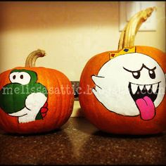 two pumpkins with cartoon characters painted on them