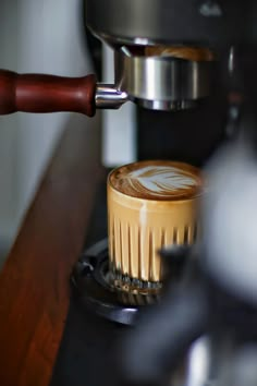 a cappuccino being made in a coffee machine