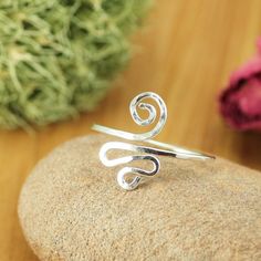 This listing is for an adjustable finger ring, in an 18 gauge sterling silver-filled* wire. This ring is perfect to wear everyday. This silver ring will be adjustable, up to 2 sizes. Look for other styles in the ring section: http://etsy.me/1z9hJmI If you prefer a toe ring or would like to coordinate, please look in the toe ring section here: http://etsy.me/1zJ9kGD *Sterling silver filled-wire is a high-quality wire product, fabricated with an everlasting thick outer layer of sterling silver, bo Adjustable Spiritual Midi Rings For Promise, Dainty Adjustable Stackable Toe Rings, Dainty Adjustable Hypoallergenic Midi Rings, Nickel-free Adjustable Minimalist Stackable Rings, Adjustable Hypoallergenic Dainty Midi Rings, Delicate Adjustable Open Midi Rings, Delicate Adjustable Open Band Midi Rings, Simple Adjustable Nickel-free Stackable Rings, Dainty Adjustable Open Midi Rings