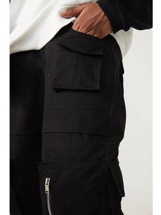 "Get ready for comfort and style with our R69 multi-pocket wide-leg Cargo Pants! With plenty of pockets for all your essentials, these pants are perfect for any adventure. Go bold with the wide-leg design and make a statement while staying practical. Don't sacrifice function for fashion with these versatile pants!" Urban Streetwear Cargo Shorts, Urban Cargo Shorts With Pockets For Streetwear, Black Cotton Cargo Jeans With Functional Pockets, Urban Style Baggy Cargo Pants With Functional Pockets, Cotton Techwear Parachute Pants With Pockets, Urban Baggy Parachute Pants With Multiple Pockets, Urban Baggy Cargo Jeans With Functional Pockets, Baggy Urban Cargo Jeans With Functional Pockets, Black Utility Work Pants With Functional Pockets