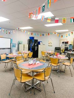 an empty classroom with many tables and chairs