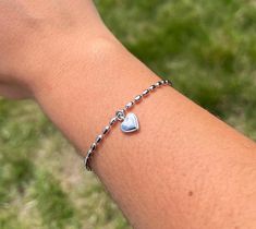 A beautiful silver bracelet which is fully adjustable up to 23cm. It comes with a gift bag. The bracelet has rhodium on so it is rust free. Looking forward to your questions 🤗 Dainty Sterling Silver Charm Bracelet For Personalized Gift, Dainty Sterling Silver Charm Bracelet With Heart Charm, Adjustable Silver Heart Bracelet For Valentine's Day, Dainty Silver Name Bracelet For Mother's Day, Valentine's Day Adjustable Silver Heart Bracelet, Silver Charm Bracelet With Adjustable Chain For Valentine's Day, Sterling Silver Bracelet With Heart Charm For Gift, Silver Heart-shaped Name Bracelet In Sterling Silver, Silver Bracelet With Heart Charm As Gift For Her