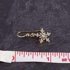 Our gold snowflake earring is a holiday accessory that is both elegant and sophisticated. These sparkly, crystal earrings can be worn every holiday season as well as all through winter, and make a great gift for a teacher or coworker. Pair with black pants and a cream sweater for a classic look on Christmas Eve. Size: earring length is 1", snowflake is 0.5" Materials: cubic zirconia Metals: gold filled ear wires, gold plated snowflakes Elegant Gold Earrings For The Holiday Season, Elegant Gold Earrings For Holiday, Elegant Snowflake Earrings For Parties, Formal Christmas Snowflake Jewelry, Elegant Holiday Dangle Earrings, Elegant Holiday Earrings For Festive Occasions, Elegant Festive Holiday Earrings, Elegant Holiday Festive Earrings, Elegant Festive Jewelry For Winter