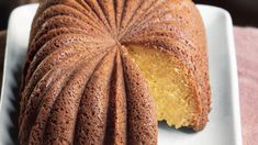 a bundt cake on a white plate with a slice cut out