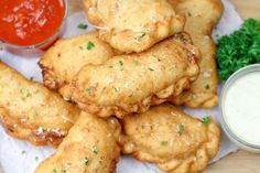 some fried food is on a plate with dipping sauce