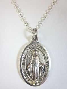 Latin Miraculous Medal Pendant NecklaceMedal design given by the Blessed Virgin to St. Catherine Labouré in 1830.Patronage: Special graces     1" Die-cast silver oxidized medal        signed Italy    20" Silver plated light link chain        spring ring clasp    Gift Boxed    Prayer card included        image detail shown Silver Necklace With Miraculous Medal As Gift, Medal Design, Silver Cross Pendant With Miraculous Medal, Vintage Miraculous Medal Necklace Gift, Vintage Silver Necklace With Miraculous Medal, Silver Pendant With Miraculous Medal, St Catherine, Miraculous Medal, Blessed Virgin