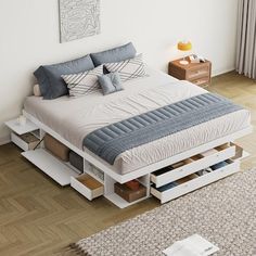 a bed sitting on top of a wooden floor next to a white dresser with drawers