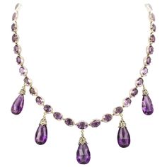 A late Victorian amethyst necklace and earrings, the necklace consisting of thirty-nine oval faceted amethyst, all set in cut-down collets, suspending five pear-shaped briolette-cut amethyst drops each with diamond-set cap of foliate design, all mounted in silver to yellow gold back, accompanied by matching drop earrings with gold wire fittings, circa 1880, the necklace measuring approximately 42 x 3.8cm, the earrings measuring approximately 3.7 x 1.3cm, gross weight 54 grams. Unmarked tested as Purple Stone Necklace, Victorian Pendants, Princess Jewelry, Beaded Bracelets Tutorial, Earrings For Sale, Amethyst Gold, Purple Necklace, Royal Jewelry, Fabulous Jewelry