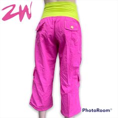 Roll Down Capri Cargo Pants In Hot Pink And Neon Green/Yellow By Zumbawear Condition: New Details: Cinchable Ankles Can Be Worn As Capris With Built-In Snaps Multicolor Button Details Roll-Down Waist Tie-Down Cargo Pockets Original Zumbawear Pants Yellow Pants With Side Pockets, Summer Sports Capri Bottoms, Summer Workout Capri Bottoms, Casual Pink Activewear With Pockets, Sporty Pink Summer Pants, Pink Cotton Gym Bottoms, Pink Cotton Sports Bottoms, Pink Cotton Activewear Long Pants, Pink Sports Bottoms For Spring