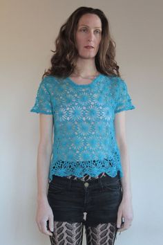 Very sweet open crochet turquoise knit flower child top. Perfect for a modern day hippy!Wear this over a small black crop top with your favorite jeans and go outside and make yourself a flower crown. Gorgeous turquoise color. Yarn is super soft. Label Made in Italy, 40% mohair, 30% acrylic, 30% nylon. Please hand wash cold water, drip dry.Very good vintage condition with no fabric or sewing flaws. Knit is delicate. MeasurementsShoulders 43cm/ 17inchesChest 92cm/ 36inchesAt hem 92cm/ 39inchesShou Bohemian Crochet Lace Top For Spring, Bohemian Spring Tops With Crochet Lace, Bohemian Open Knit Crop Top, Handmade Bohemian Blue Tops, Handmade Blue Bohemian Tops, Fitted Turquoise Bohemian Tops, Fitted Bohemian Turquoise Tops, Handmade Blue Tops For Festival, Fitted Hippie Tops With Crochet Trim